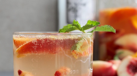 Light and summery white wine sangria with stone fruit and whiskey
