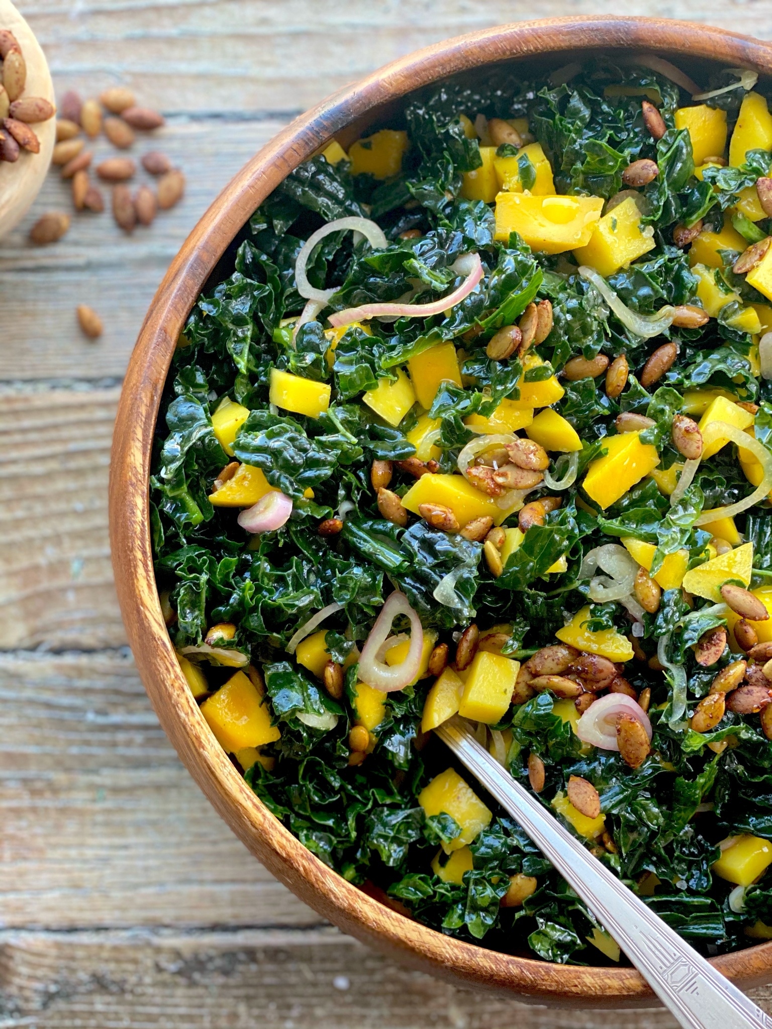 easy kale salad with mango, spiced pepitas & pickled shallots